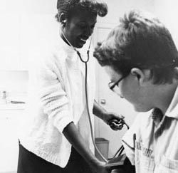 A school nurse takes a students blood pressure