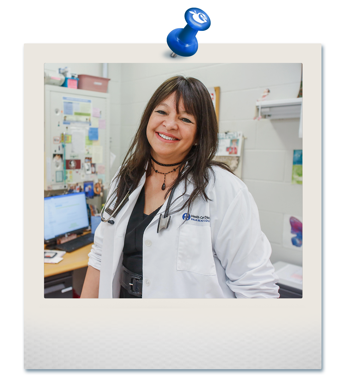Woman nurse on an office wearing a white coat while smiling