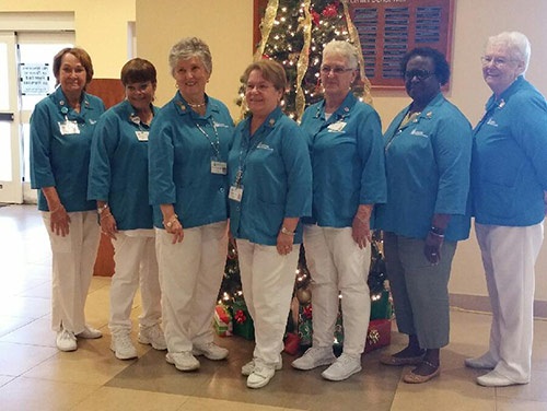Part of the Lakeside Auxiliary team standing in a row wearing blue Lakeside shirts