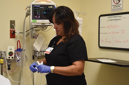 Annette in purple gloves handling medical equipment