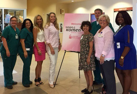 Group photo of Lakeside staff standing around a sign that reads Welcome Susan G Komen