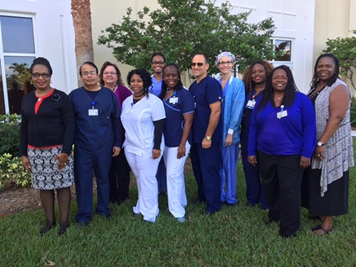 Group photo of the nursing management team standing outside in the grass at Lakeside Medical Center