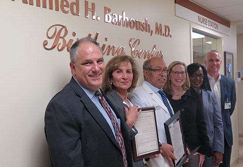 Dr. Barboush takes a photo with HCD board members and executives