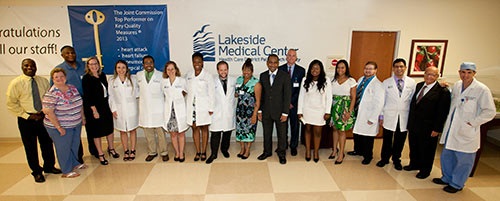The group standing inside Lakeside Medical Center in a line for a wide angle photo