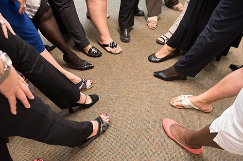 Women's showing their shoes in represention of A number of shoes to fill