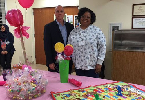 Cynthia Jarrell poses with Rick Roche for the employee of the month photo