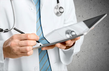 Close of a doctors hands holding a tablet and using a stylus