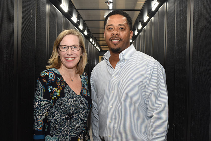 Darcy and Walton standing side by side in the data center