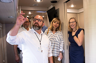 H C D Staff walking through the inside of the mobile unit