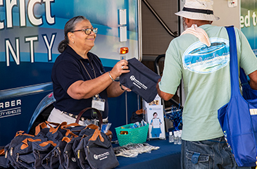 Outreach worker with patient in front of the Mobile Health Clinic