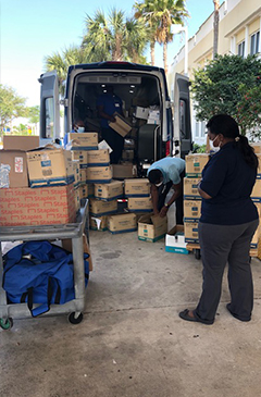 Donated supplies being unloaded from van