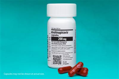 Bottle of Molnupiravir with maroon capsules next to it