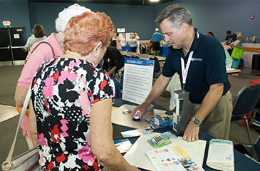 Image of David Summers, RN speaking with two women