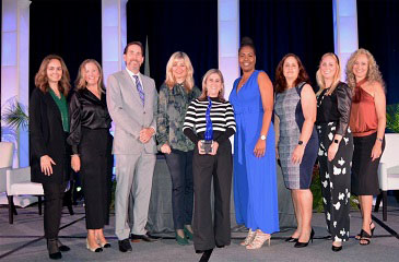 Clinic team on stage receiving the Sapphire Award