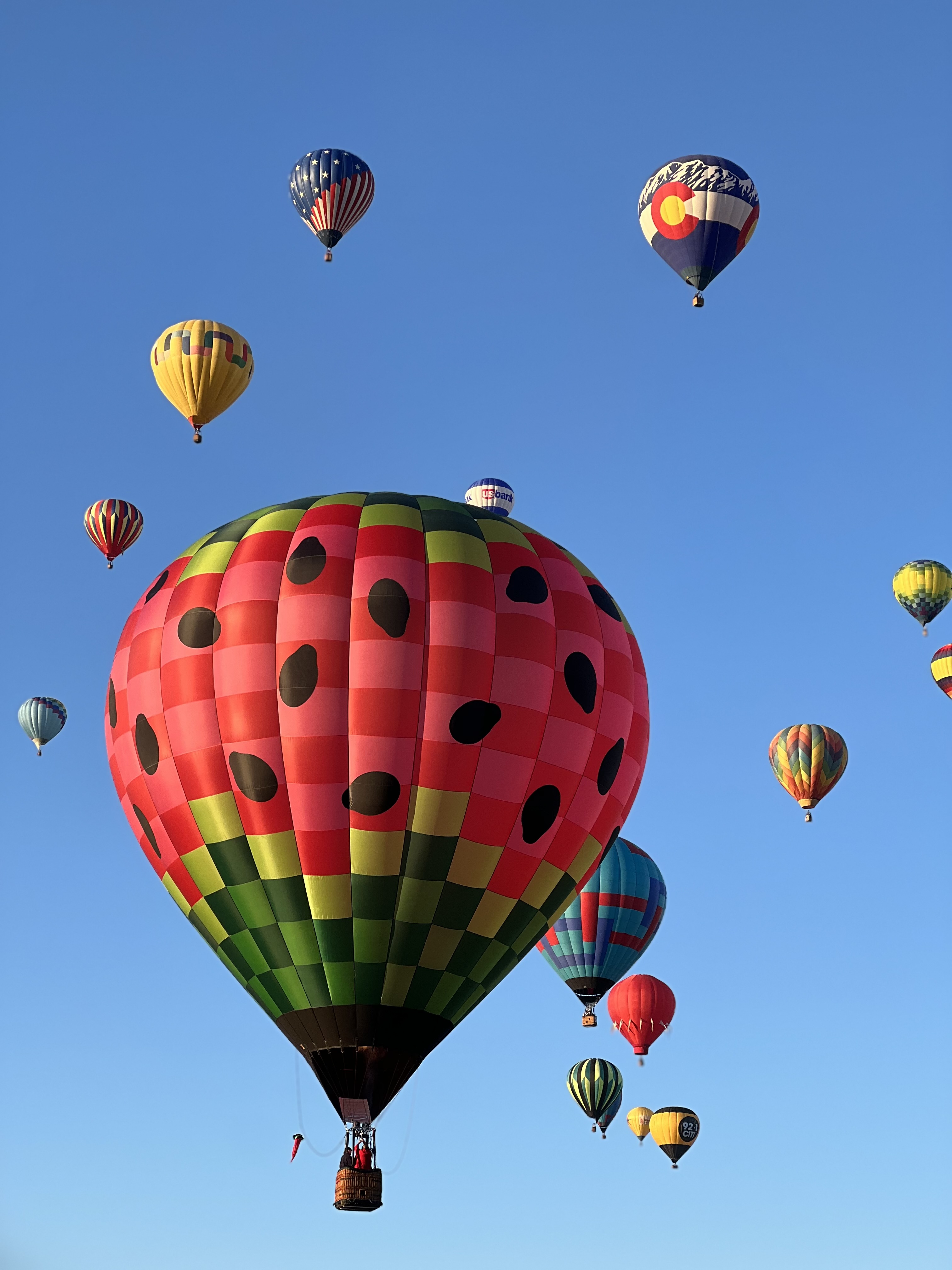 Balloons in the sky with one in the foreground