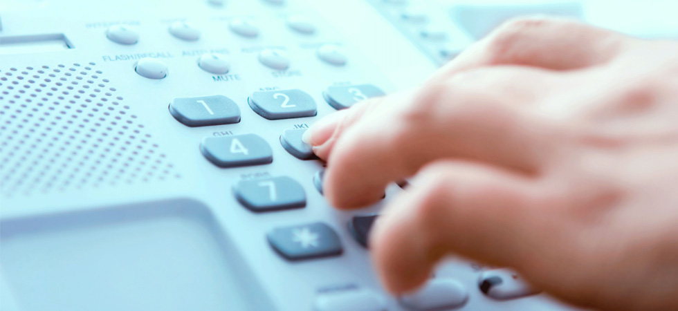 Close up photo of a hand dialing a phone