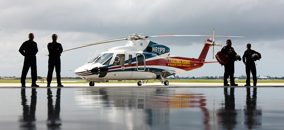 Trauma Hawk flight crew standing to the left and right of the helicopter