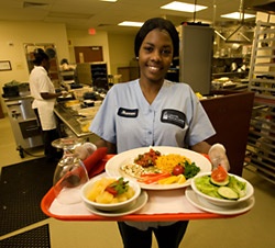 A tray of food  being presented by food services